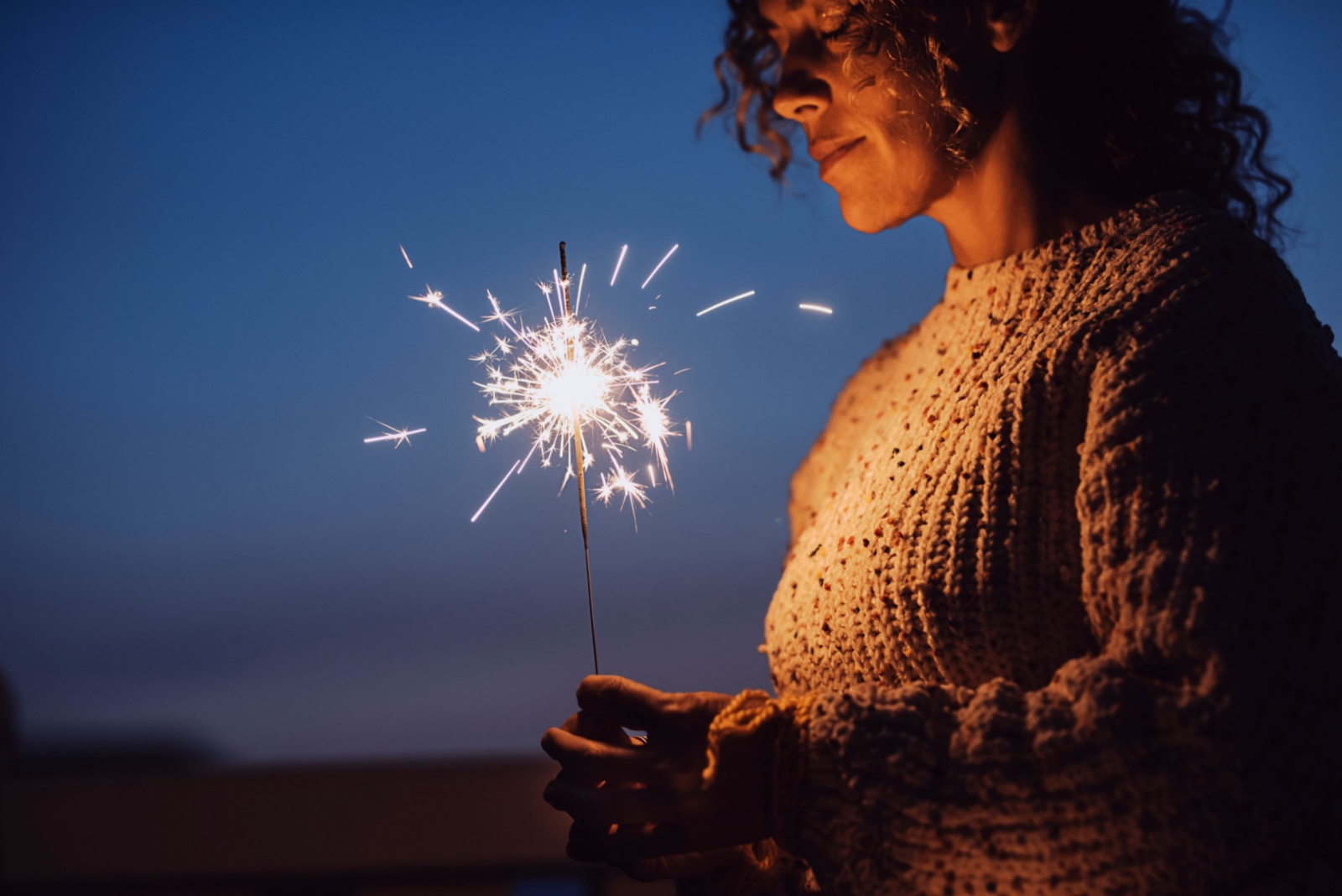 woman holding a sparkle