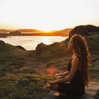 woman meditating in sunrise