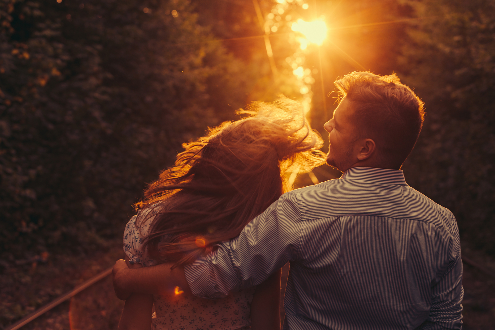 a man and a woman sit embracing