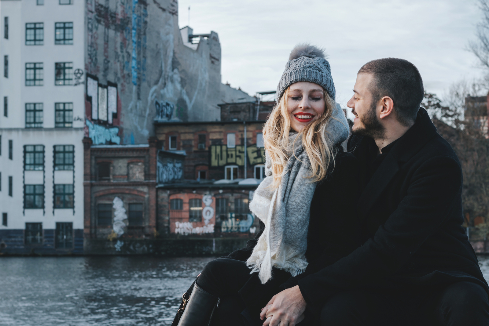 a man and a woman sit outdoors and talk