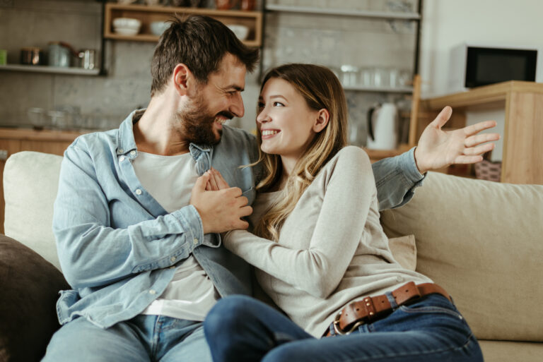 a smiling woman in the arms of a man