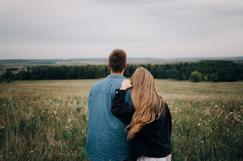 couple looking at landscape and hugging