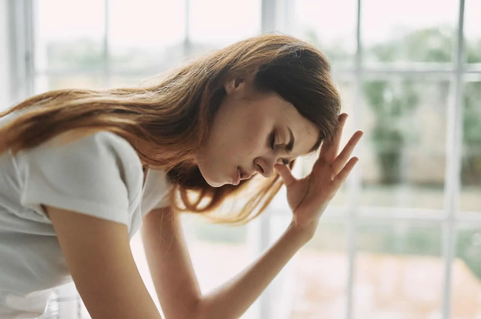 distraught girl holding her head