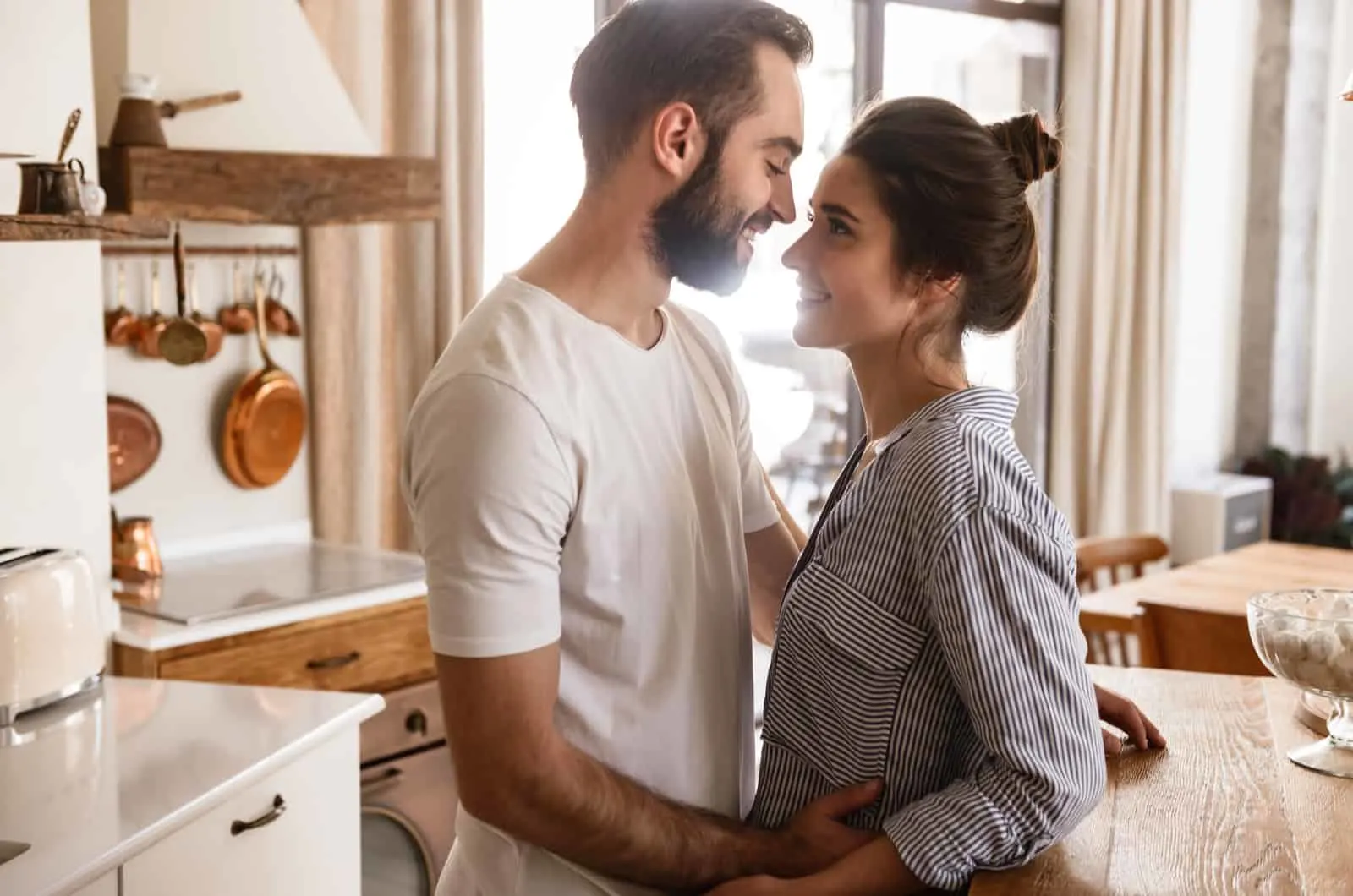 happy couple standing in kitchen
