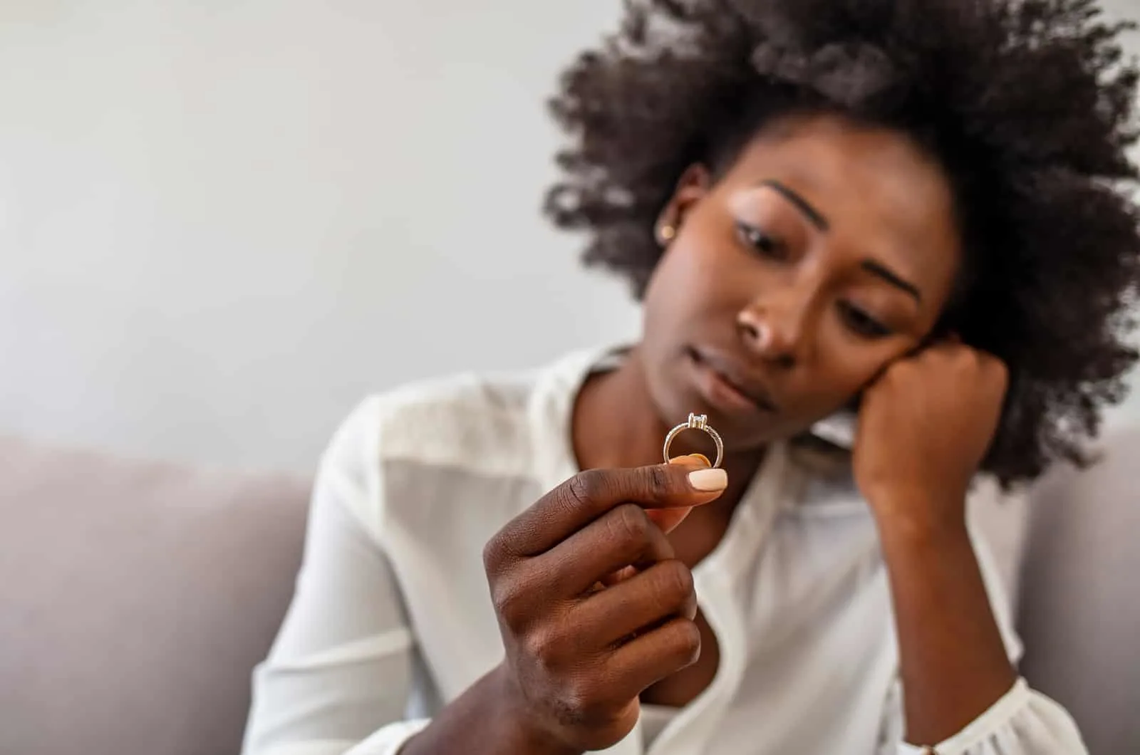 sad woman holding ring