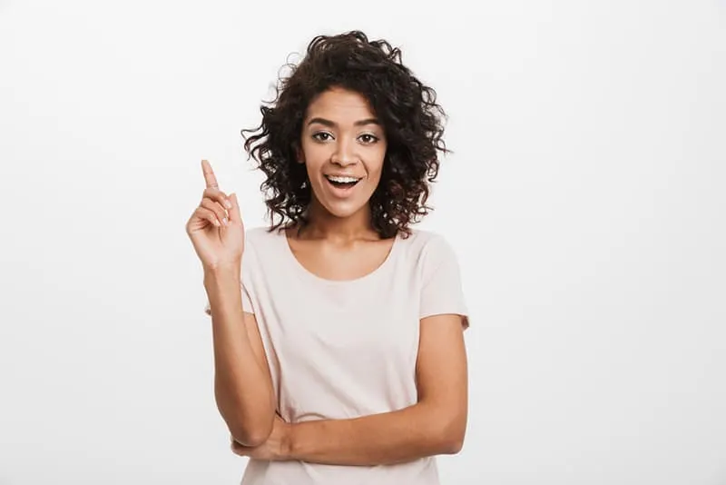 smiling woman pointing finger up