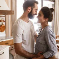 couple embracing in kitchen