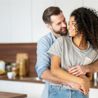 a couple in love standing embracing in the kitchen