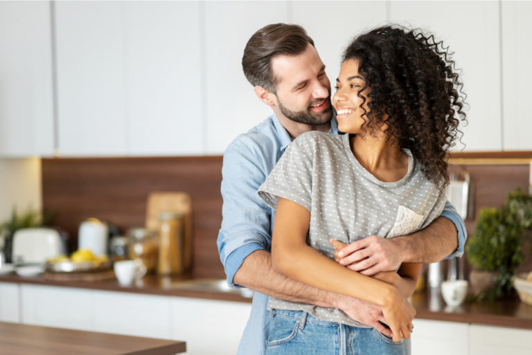 a couple in love standing embracing in the kitchen