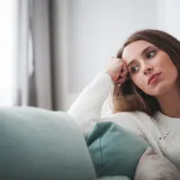 anxious woman sitting on couch