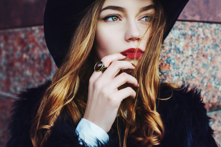 an imaginary woman with a black hat on her head