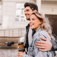 happy couple walking having coffee
