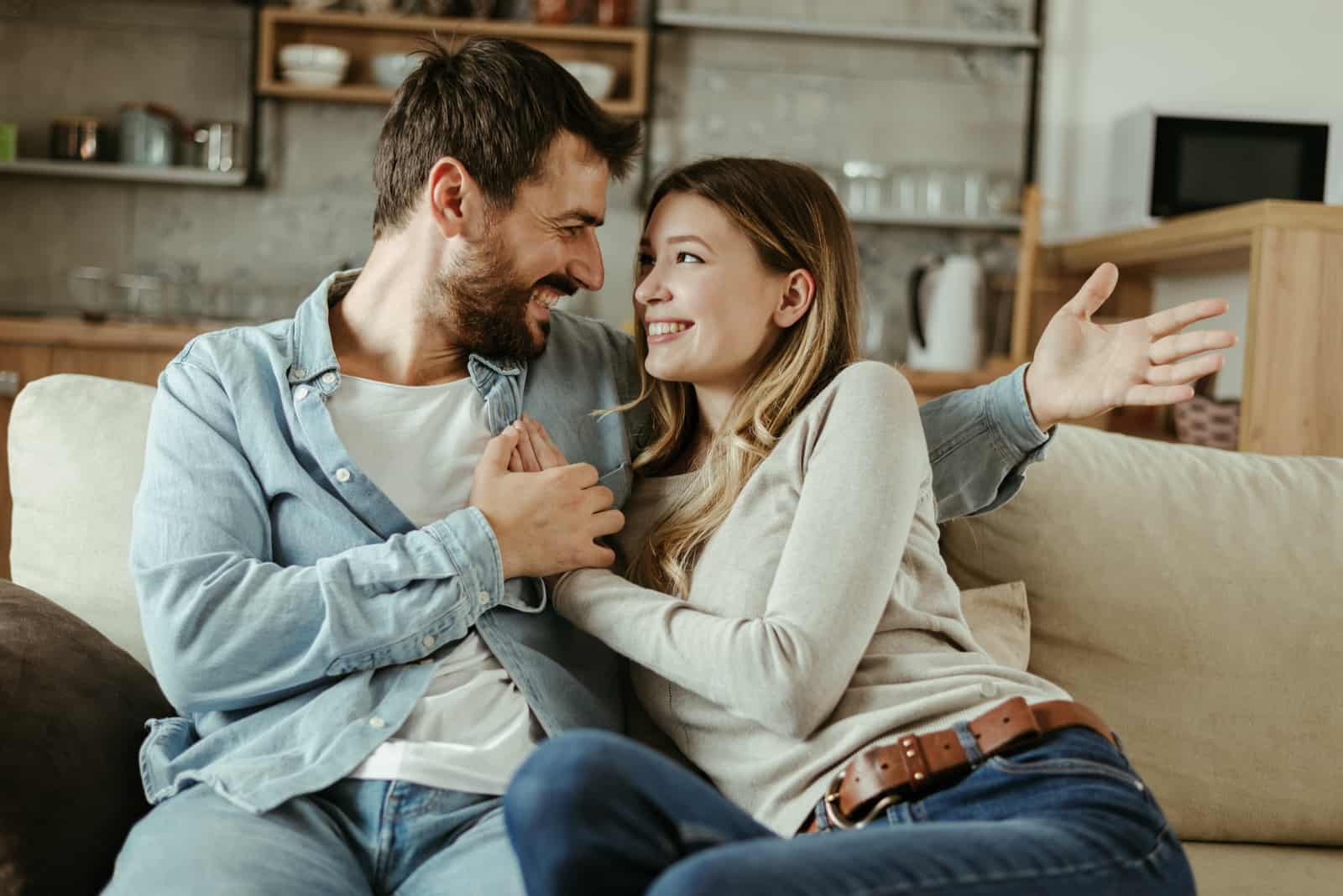 a couple in love embracing sitting on the couch