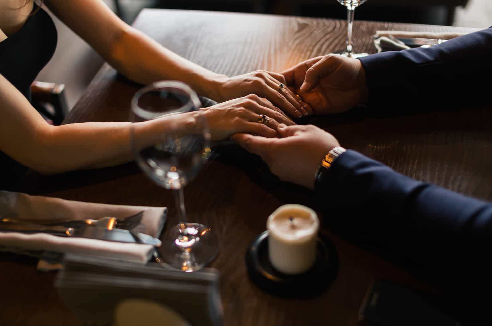 dressed up couple holding hands