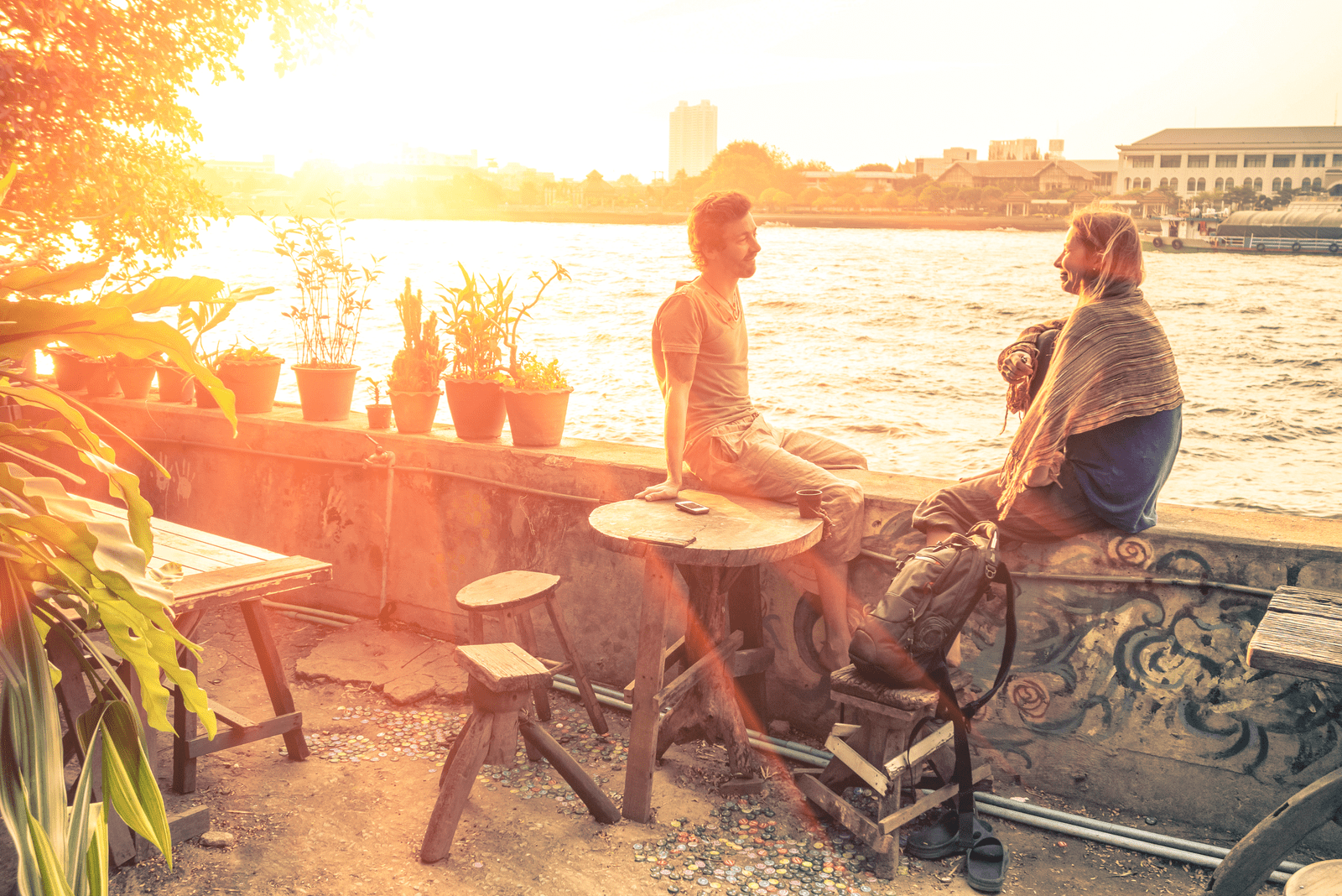 a man and a woman sit on the wall and talk