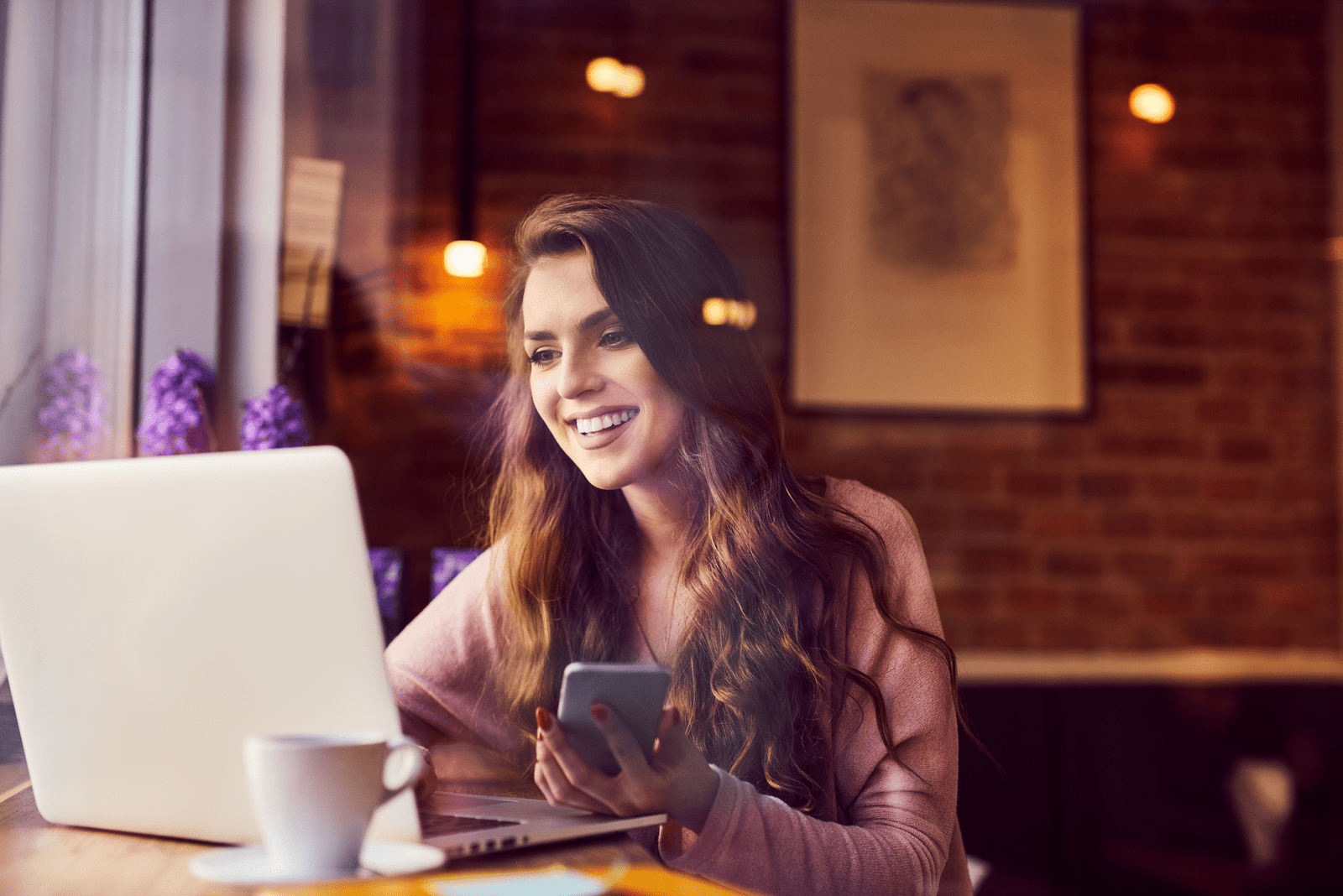 a smiling woman sitting in a cafe