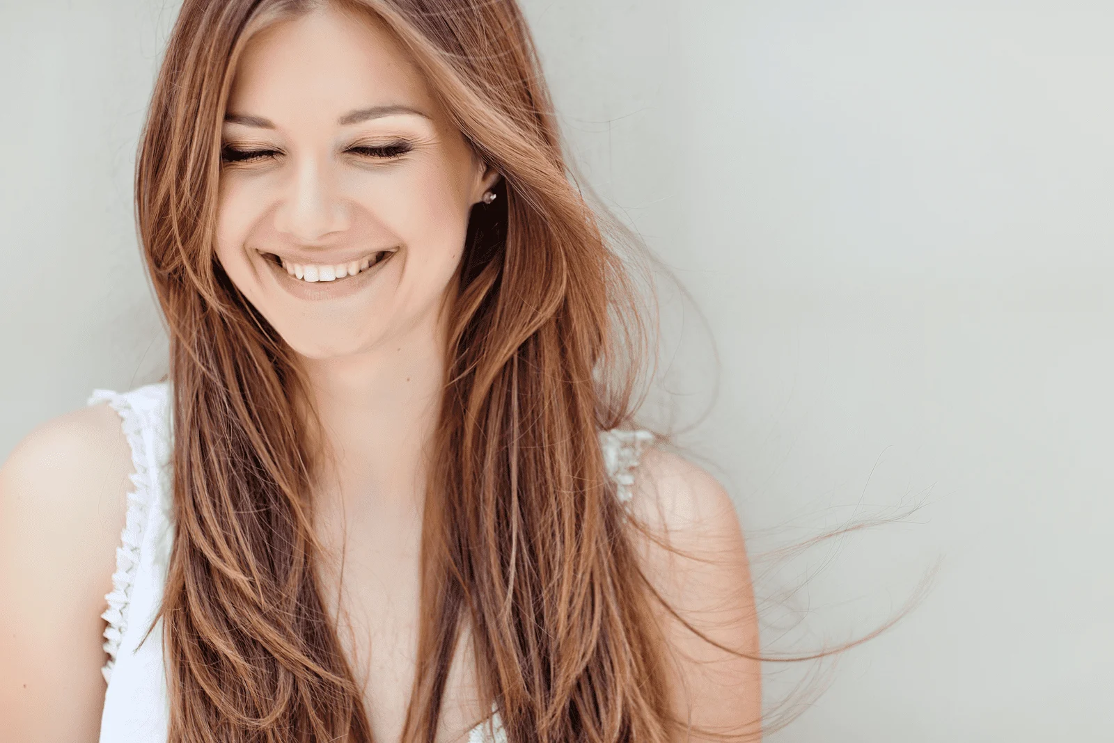 a smiling woman with long brown hair