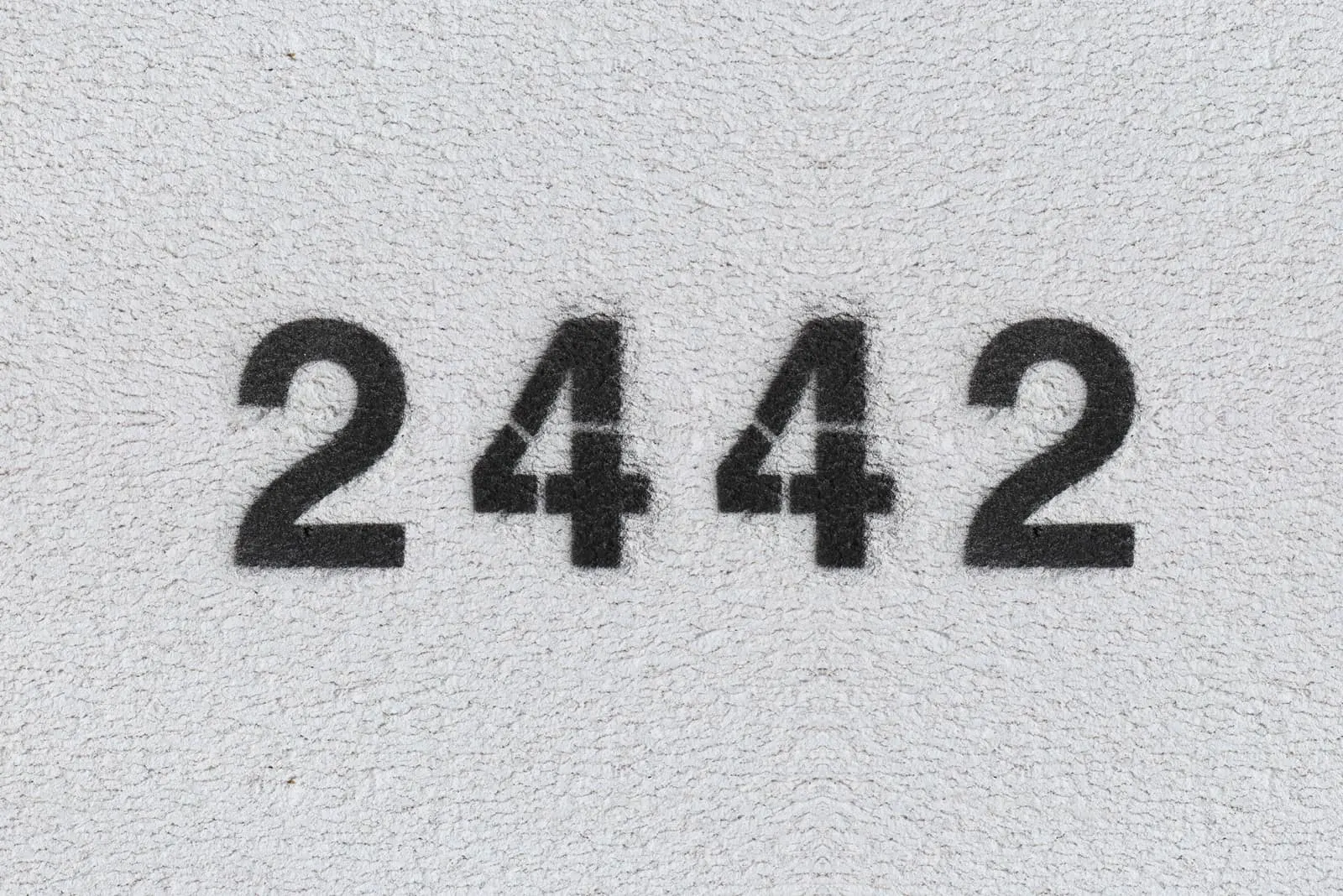 black 2442 angel number with grey background