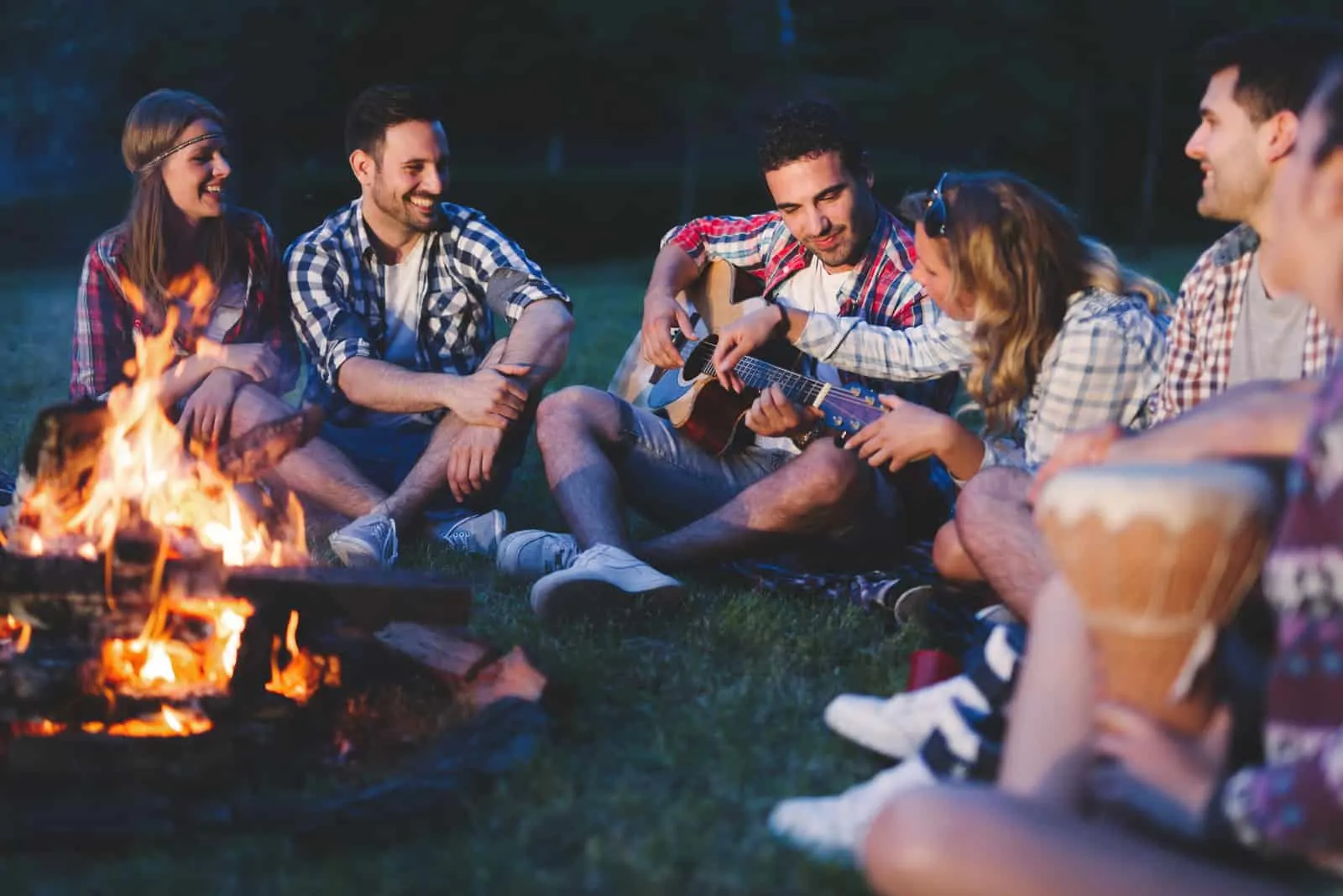 gemini man testing girlfriend's social skills while being on bonfire with friends