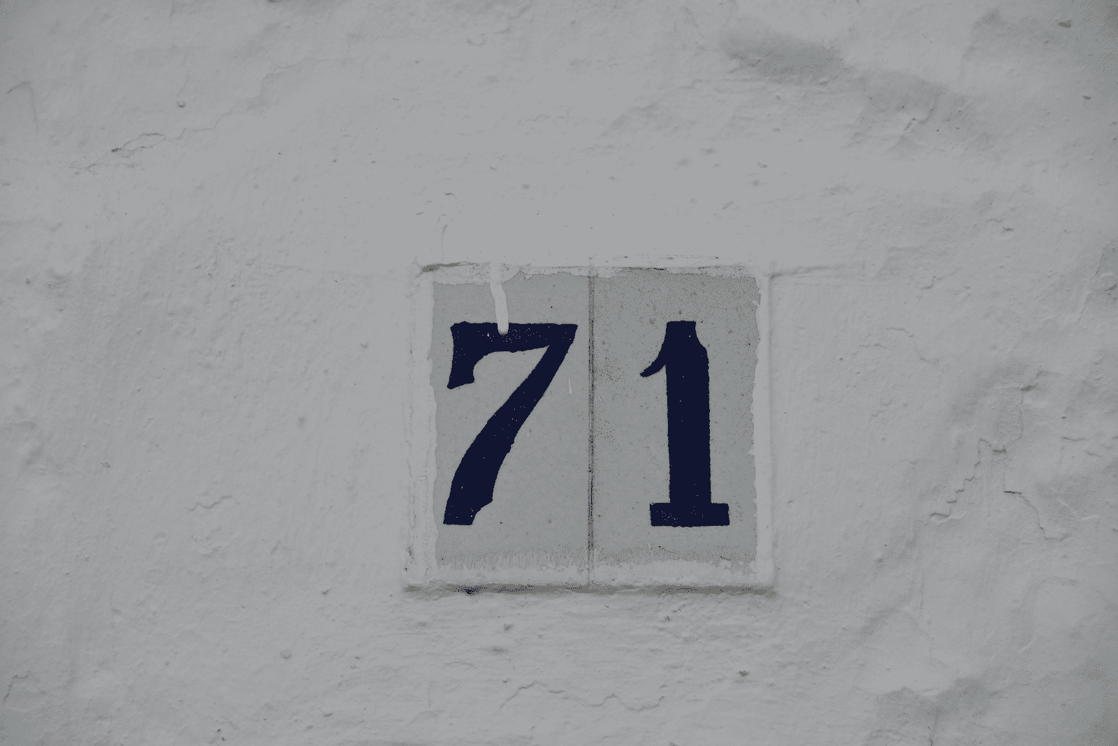 number 71 on the wall of the house