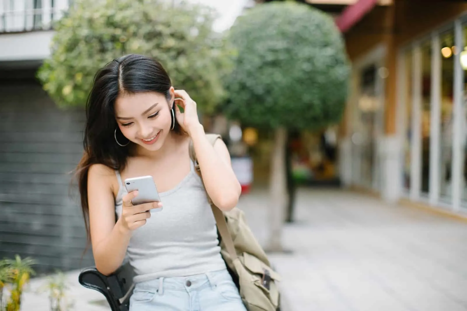 smiling woman with long black hair button on the phone