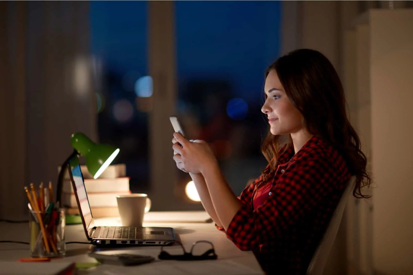 woman working at night responding to i miss you text