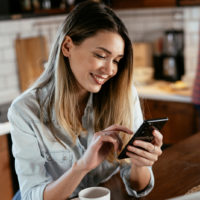 smiling woman texting on phone