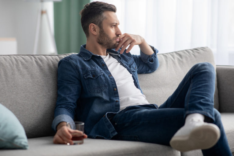 a sad man sitting on the couch