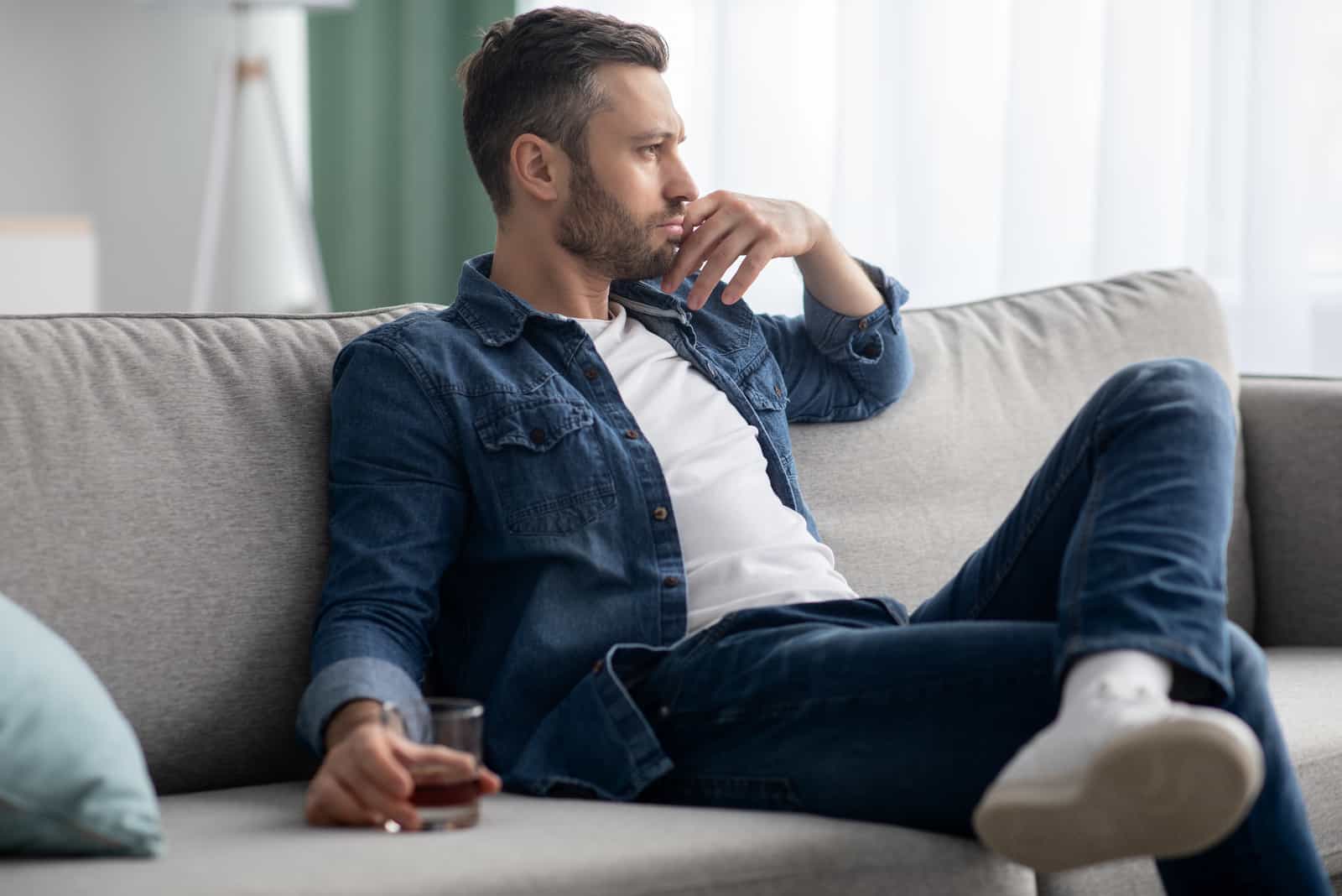 a sad man sitting on the couch