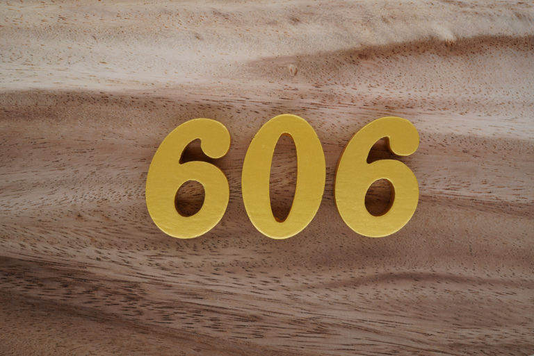 606 angel number on a wooden base