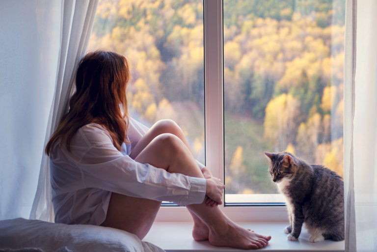 an imaginary woman sitting by the window