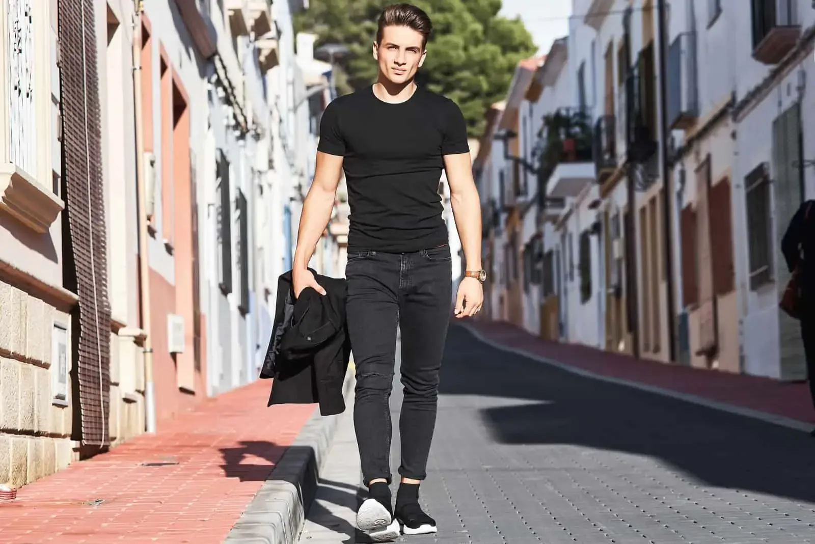 a beautiful man walks down the street