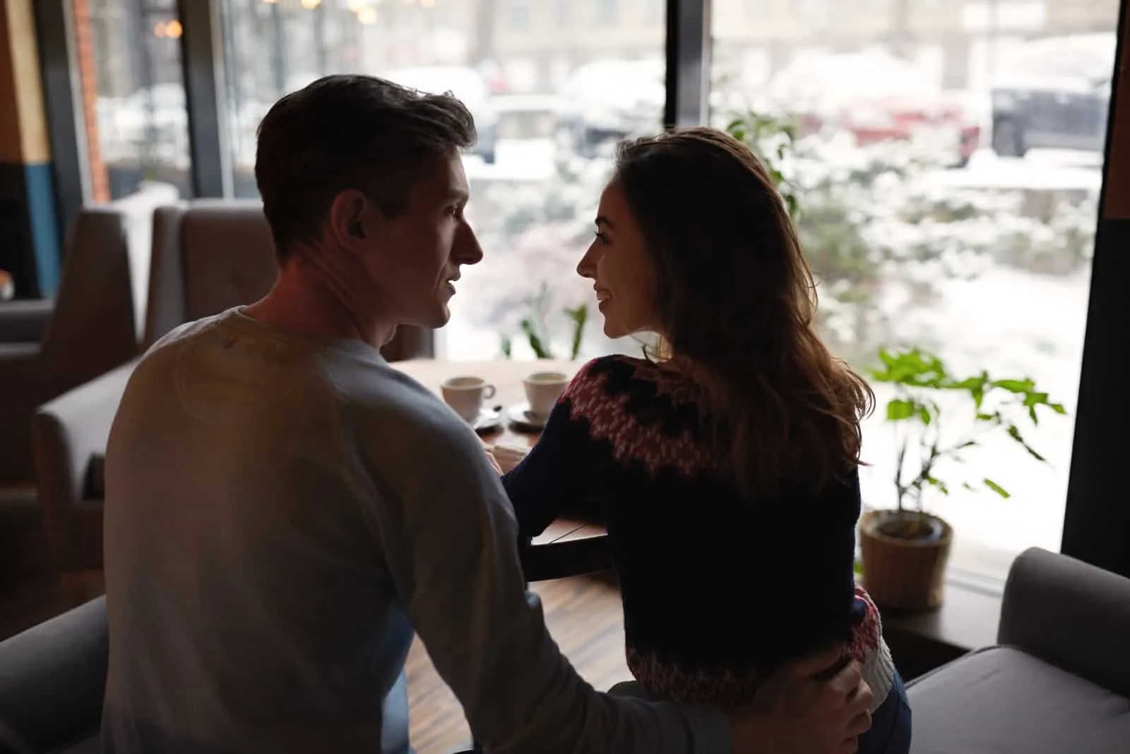 a woman in the arms of a man talking