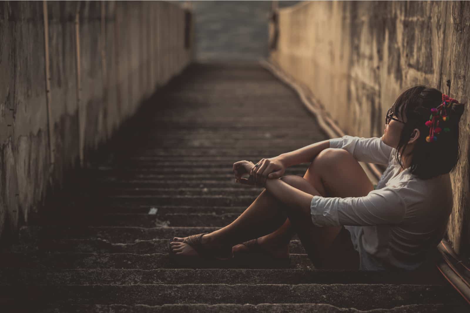 una mujer imaginaria sentada en las escaleras