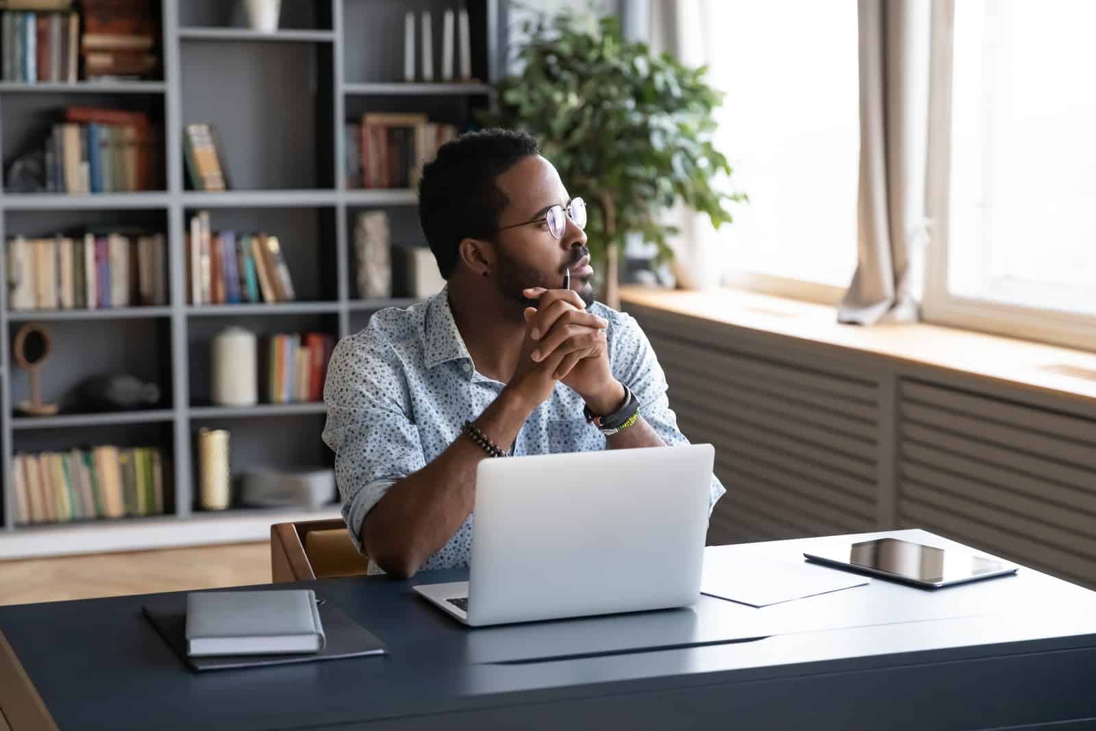 men working on his laptop looking away