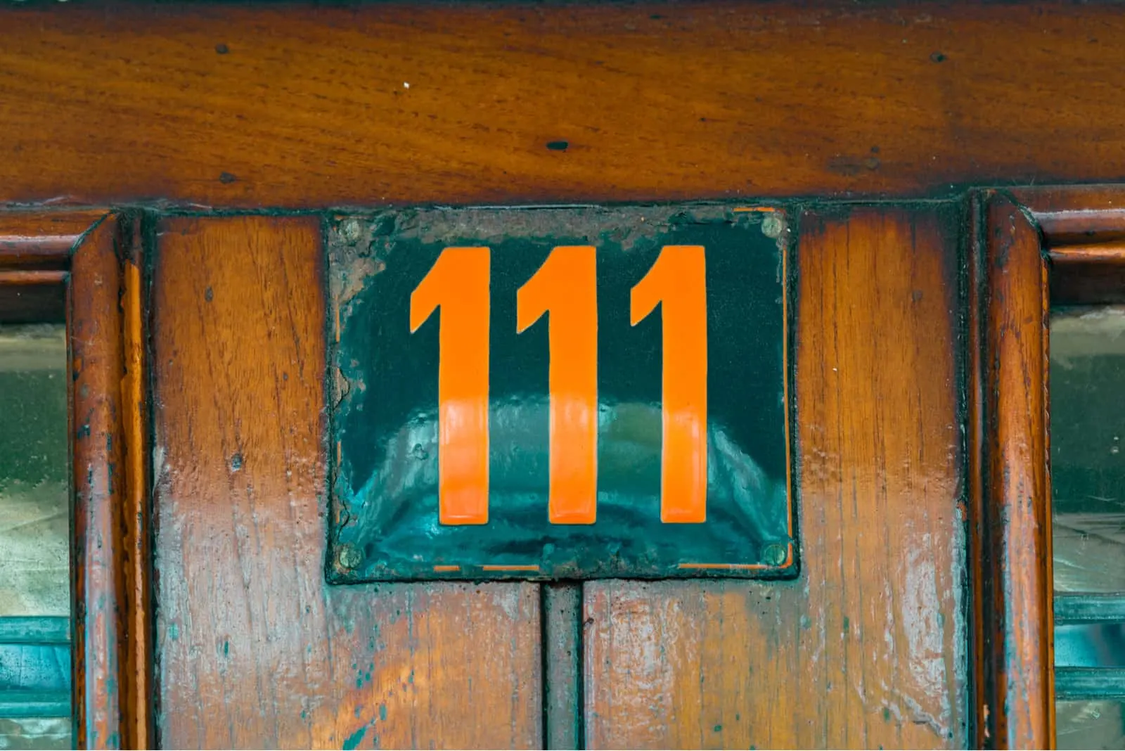 number 111 on a wooden door