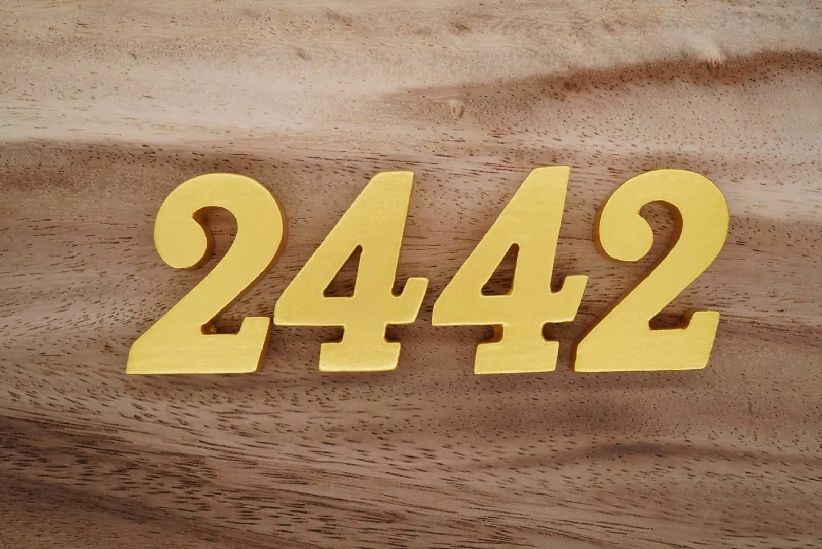 number 2442 on a wooden base