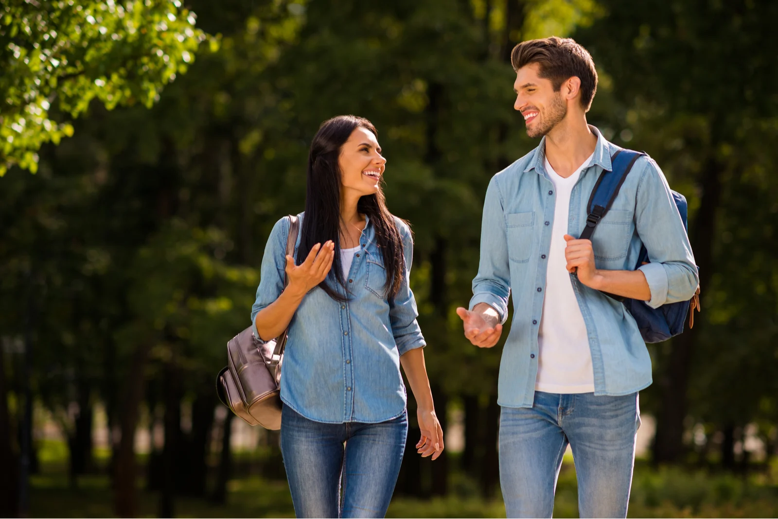 smiling loving couple sets in the park