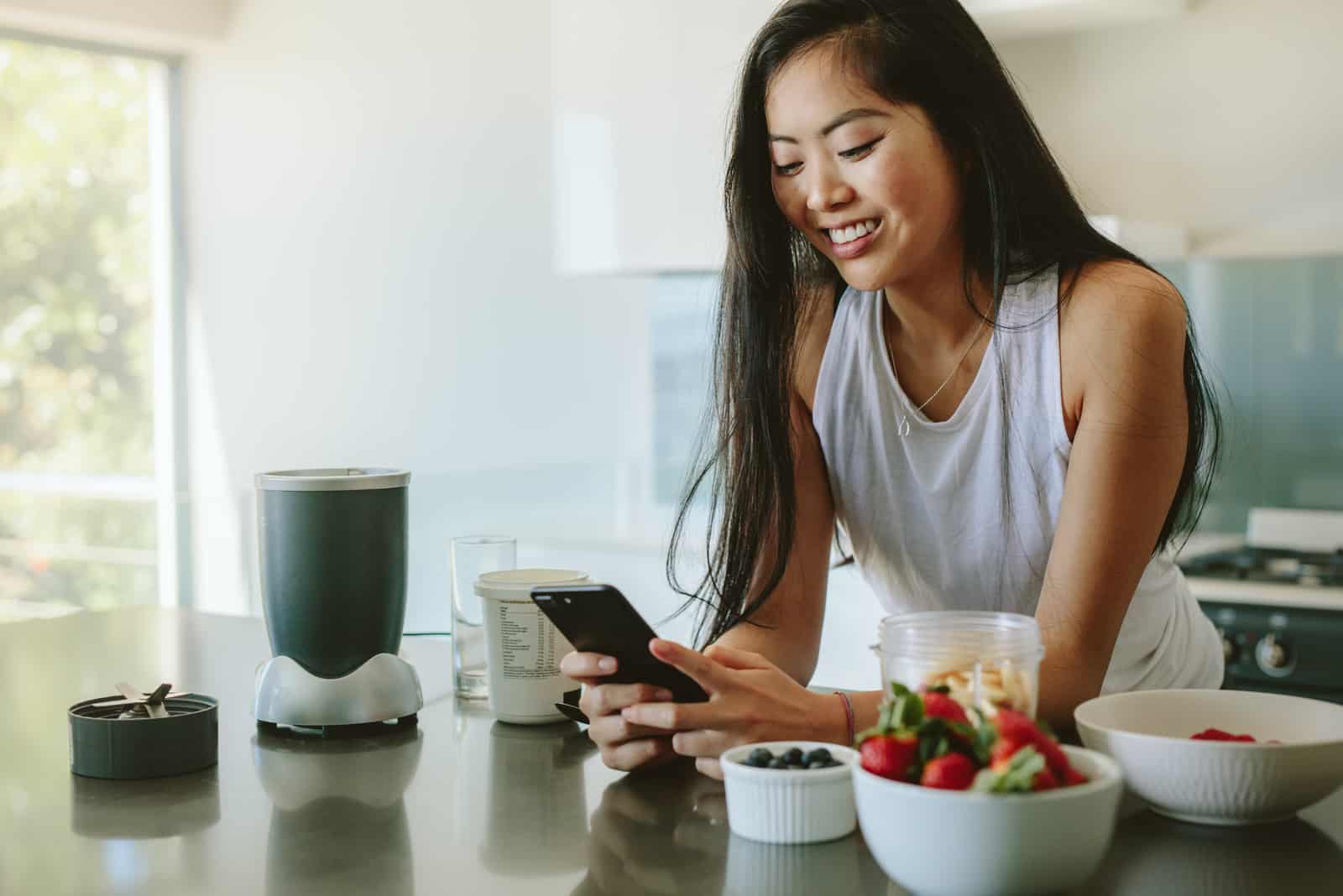  woman standing in kitchen thinking about 9 texts to get him chasing you