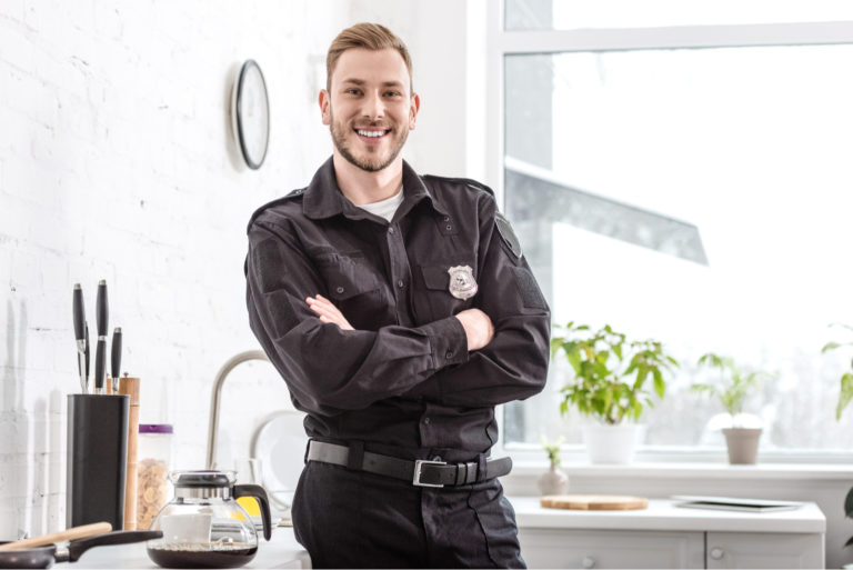 a smiling man stands in the office
