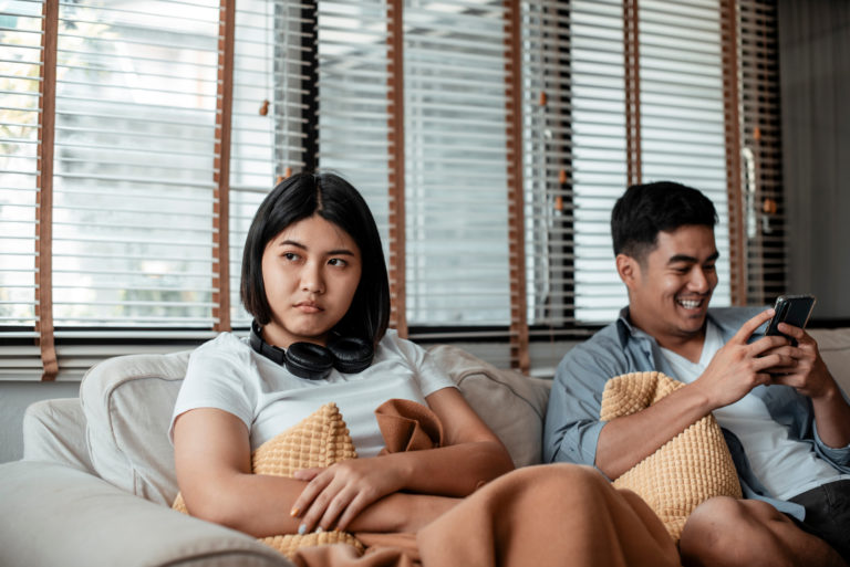 man ignoring a woman sitting next to him