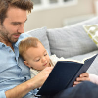 man reading to his son