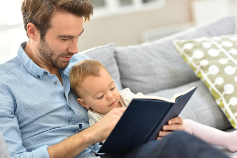 man reading to his son