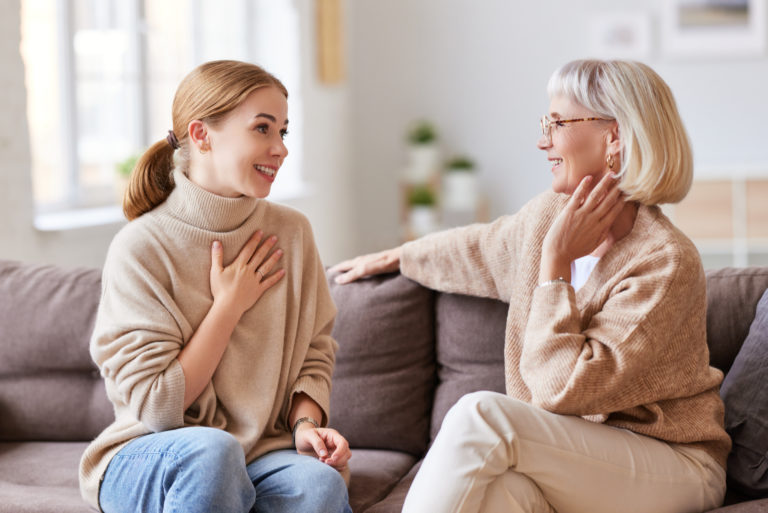 the woman sits and talks to her mother-in-law