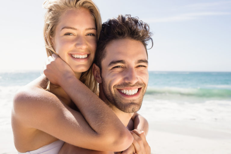 a smiling woman hugged the man