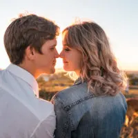 couple kissing at sunset