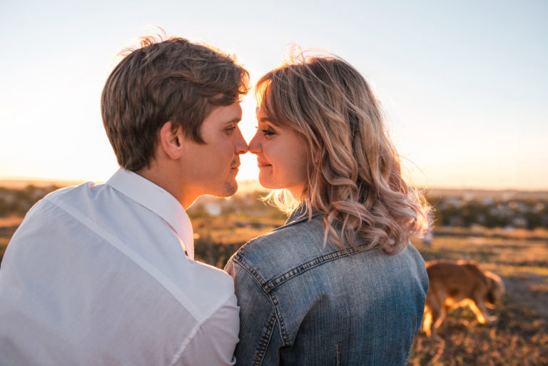couple kissing at sunset