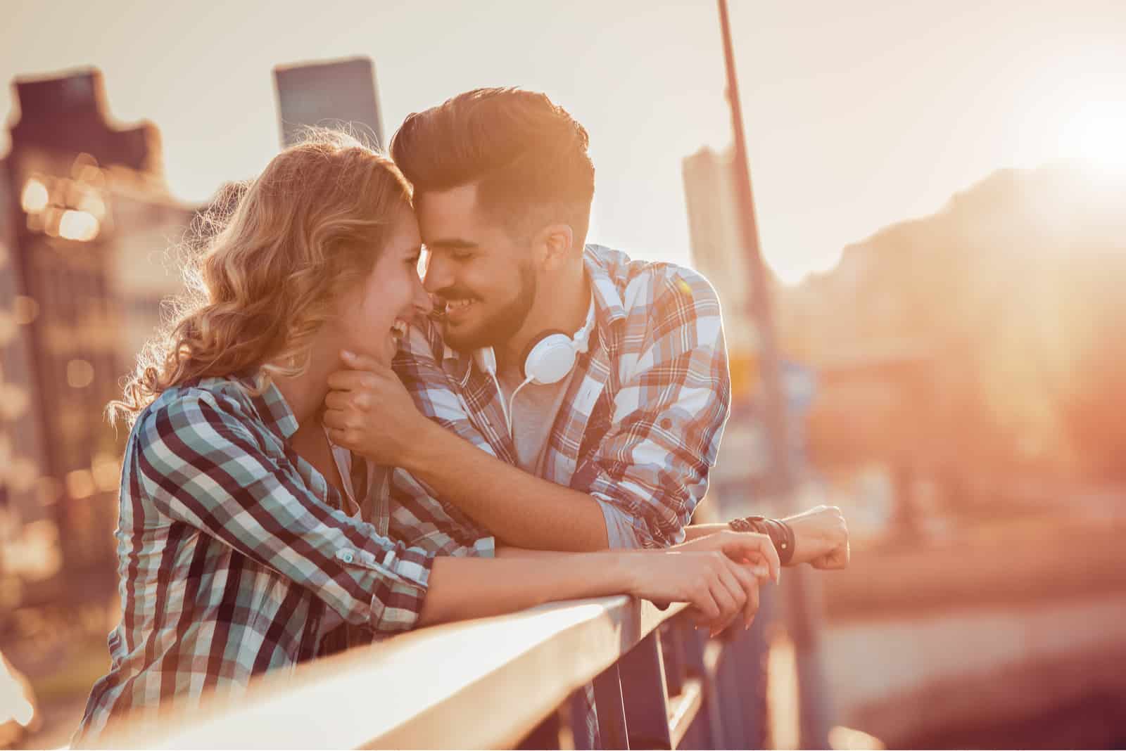 a beautiful man caresses a woman's face