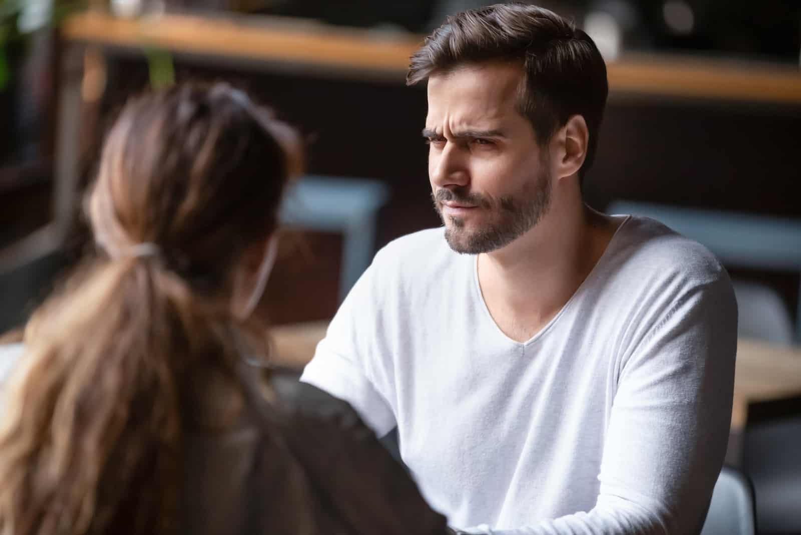 a disappointed man talking to a woman