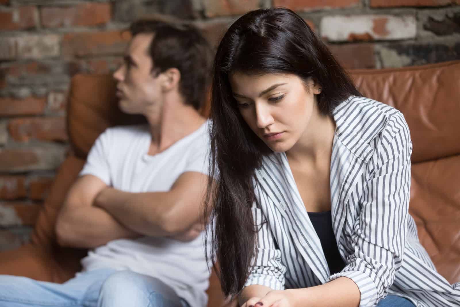 a woman with long black hair turned her back on the man